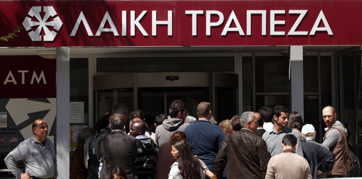 People waited impatiently for a Laiki bank branch to open March 28 after an 12-day lockdown in Nicosia, Cyprus.