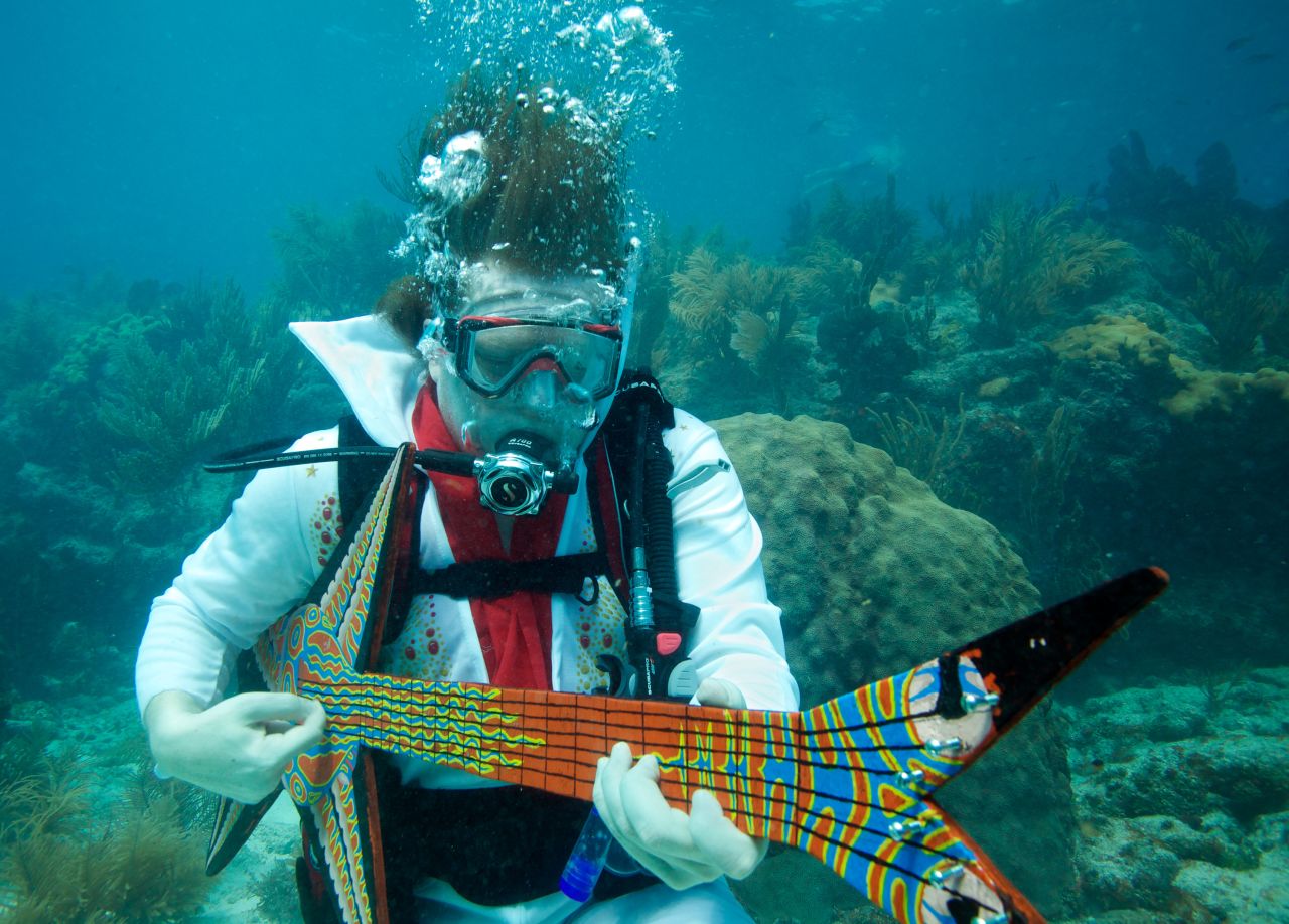 Eric Rolfe, costumed as "Eel-vis Presley" strums on a fake guitar during the Lower Keys Underwater Music Festival in 2011. Check out this year's event in July.