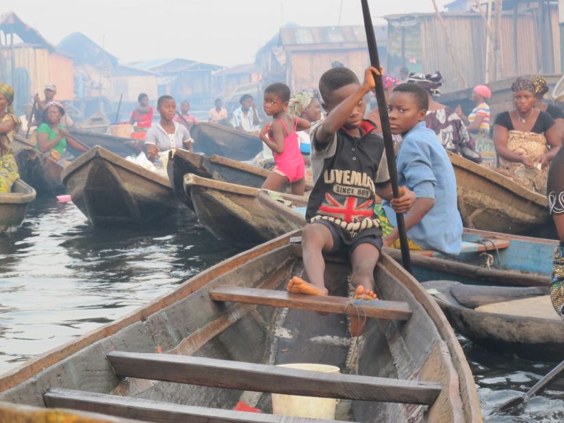 Just like any other bustling town, there's a rush hour in Makoko. Most children appear comfortable steering canoes as it is the only mode of transportation in an all-water community, but they must be careful. 