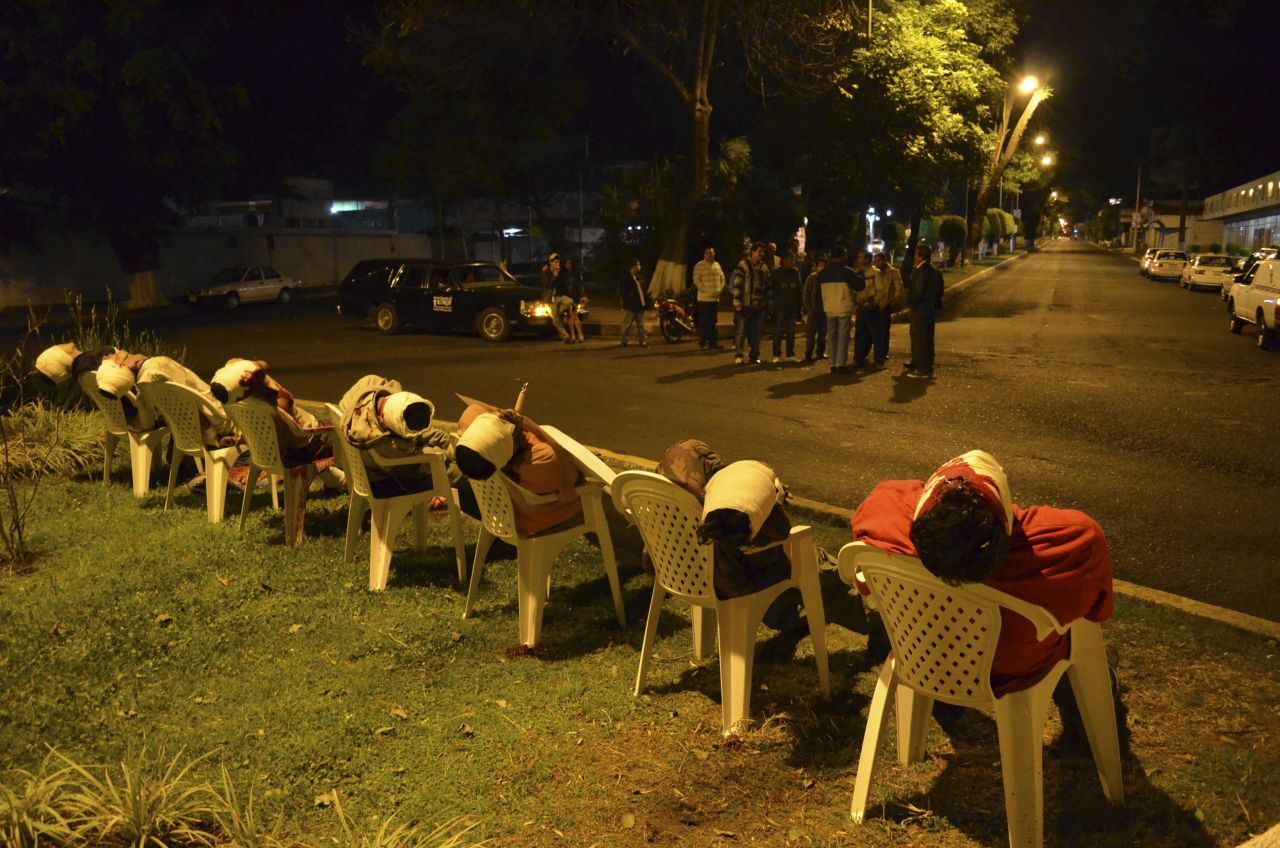The bodies of seven men arranged in chairs are pictured in Uruapan, in the Mexican state of Michoacan, on March 23.  The men were shot in the head with threat messages nailed to some of their chests using ice picks.