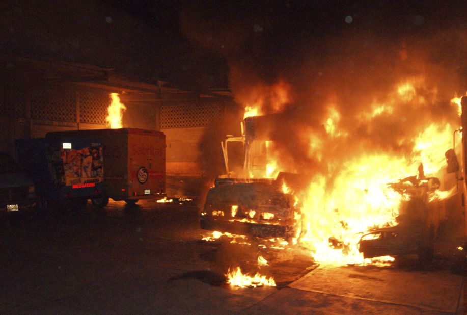 Delivery trucks from the Mexican snacks company Sabritas burn after assailants set them on fire at a warehouse in Lazaro Cardenas, in the Mexican state of Michoacan, on May 26, 2012. At least three warehouses and 28 vehicles were damaged in a series of coordinated arson attacks against the company in the towns of Lazaro Cardenas, Uruapan and Apatzingan. Drug cartel members posted banners saying the snack company let law enforcement agents use its trucks for surveillance, a charge the company denied.