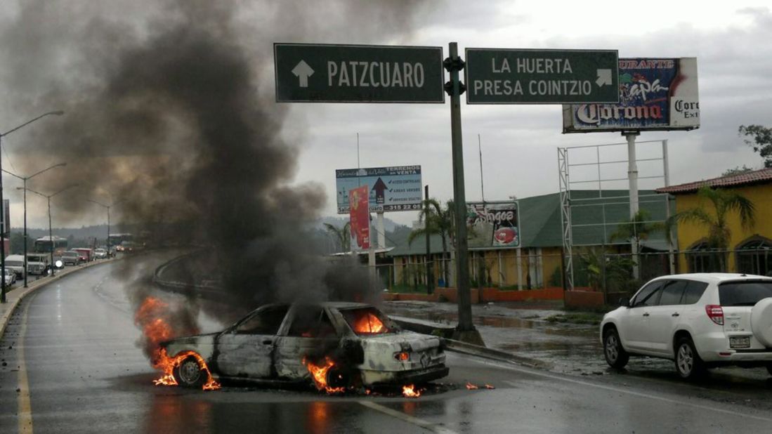 A car burns after several clashes between federal agents and allegedly hired killers in Michoacan on July 7, 2011. The clashes took place in Apatzingan, Uruapan and Maravatio.
