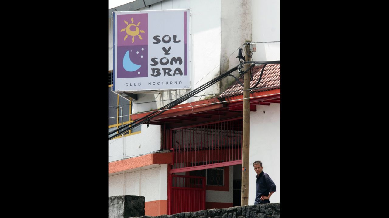 A man stands in front of the "Sun and Shadow" nightclub, where gunmen in ski masks rolled five severed heads onto the dance floor, on the edge of the city of Uruapan on September 7, 2006.