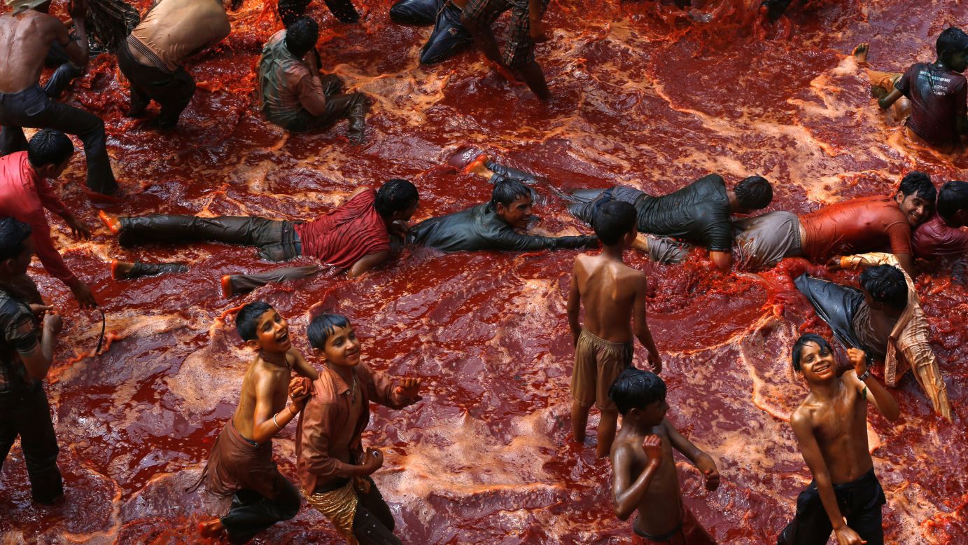 Men are dragged on the ground to cover them in red water during huranga on March 28.