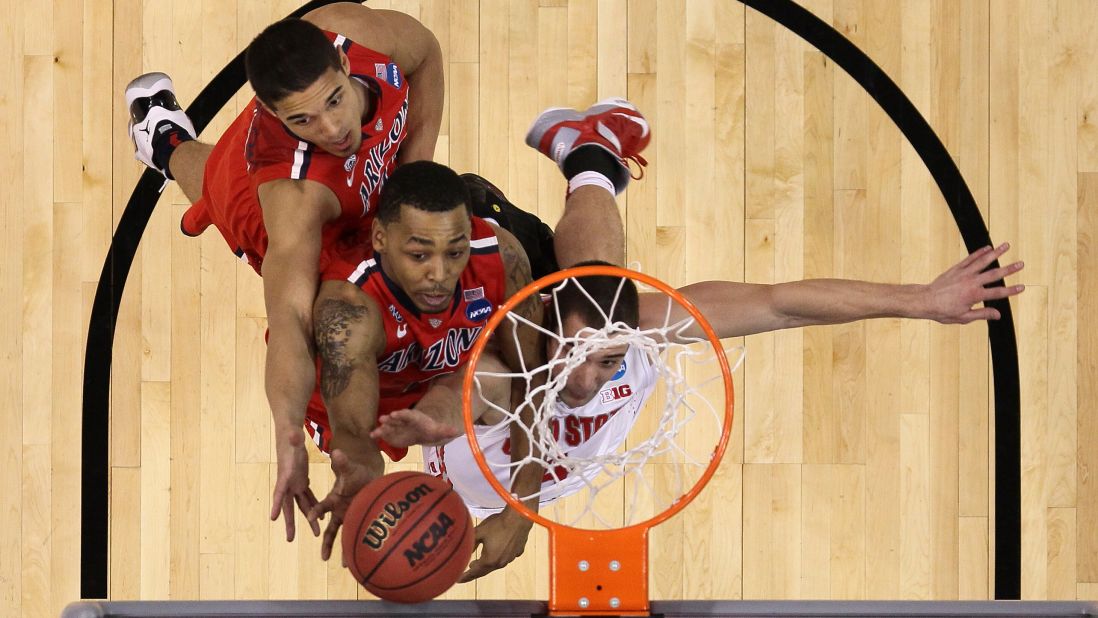 Nick Johnson, left, and Mark Lyons, center, of the Arizona Wildcats battle Aaron Craft of the Ohio State Buckeyes for a rebound on March 28 in Los Angeles.