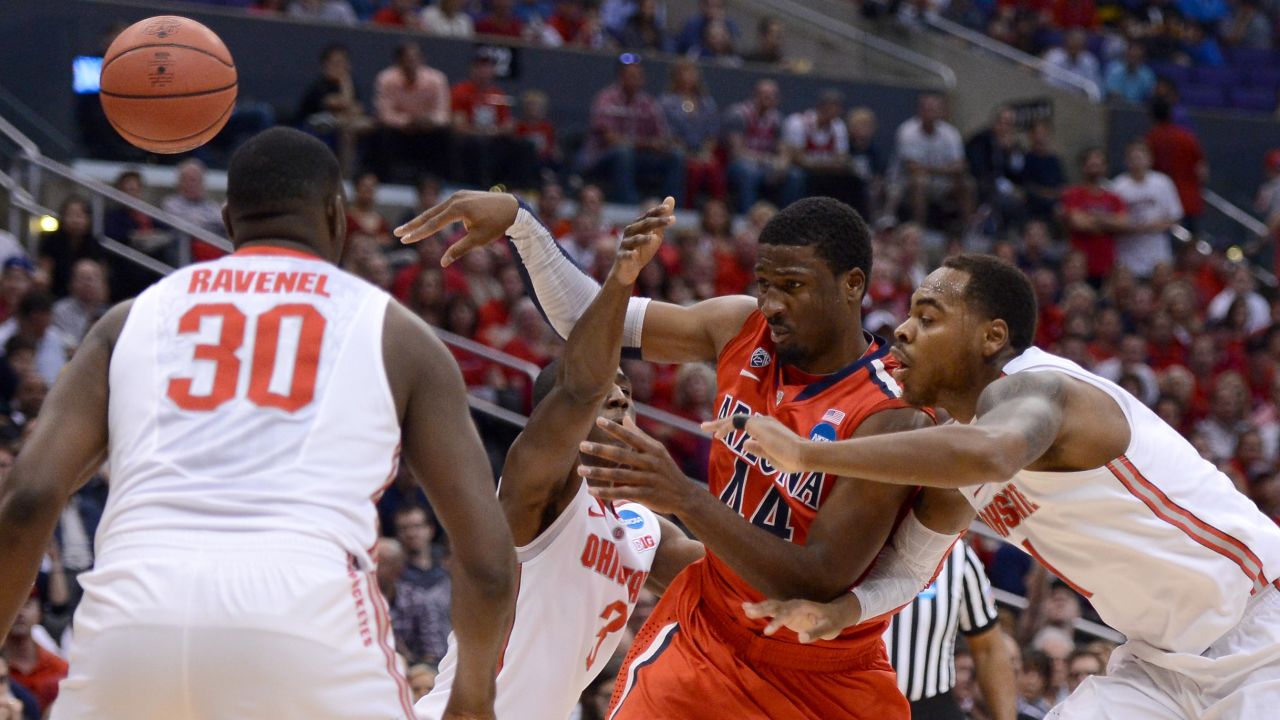Solomon Hill of Arizona, second from right, passes the ball against Deshaun Thomas, right, of Ohio State on March 28.