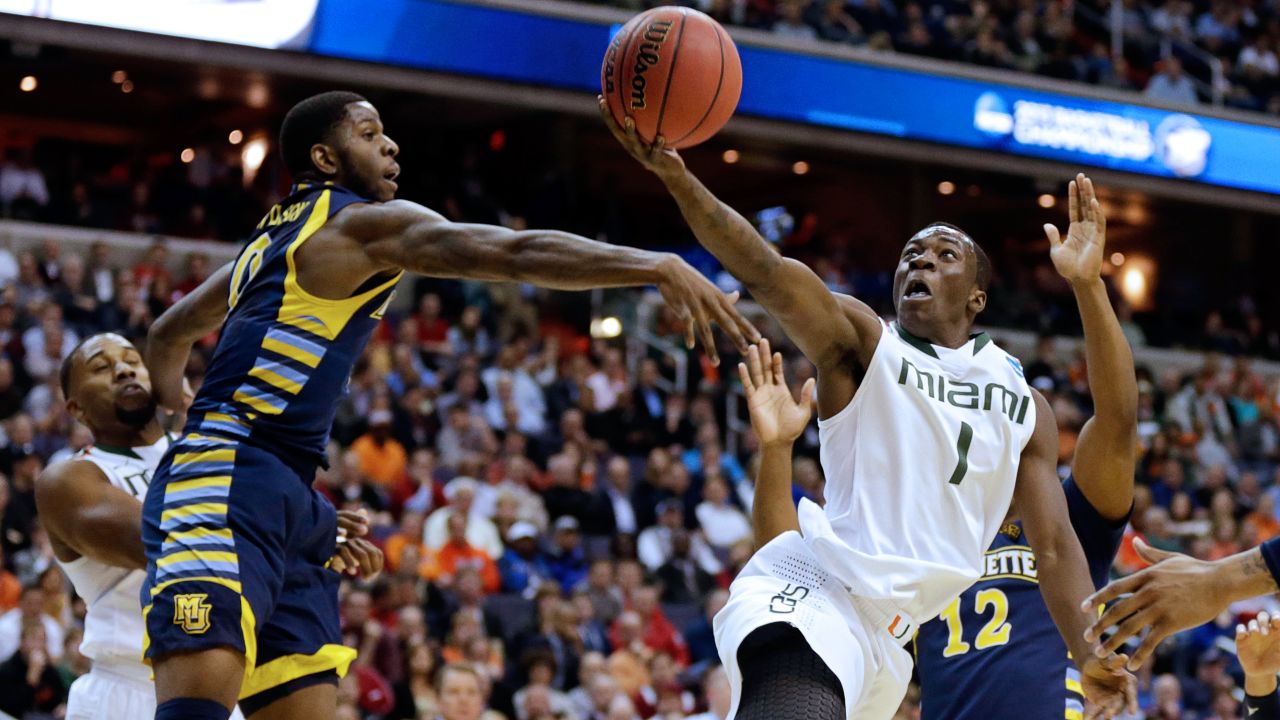 Durand Scott of Miami goes to the hoop against Jamil Wilson, left, of Marquette on March 28 in Washington.