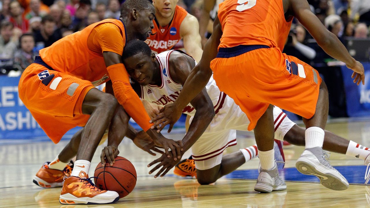 Victor Oladipo of Indiana fights for the loose ball against, left to right, Baye Keita, Brandon Triche and C.J. Fair of Syracuse on March 28.