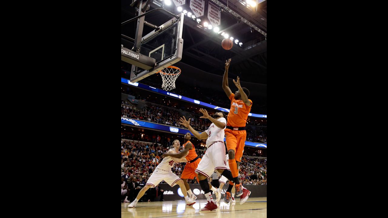 Jerami Grant of Syracuse, right, shoots the ball over Christian Watford of Indiana on March 28.