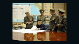 On the left side of the photo there is a white paper with lines which appears to be a map. The title in Korean of the map is: "Plan for the strategic forces to target mainland U.S." If you view it carefully, there is a line leading to what appears to be Hawaii and California.