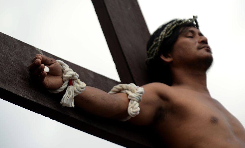 A penitent is nailed to a cross during the reenactment of crucifixion on Good Friday in the village of San Juan, San Fernando City, north of Manila.