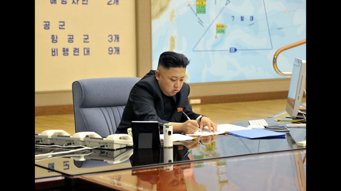 Kim works during a briefing in this undated photo.