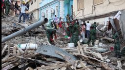  People search through the rubble after a building collapsed along Indira Gandhi and Asia streets in Dar Es Salaam Tanzania on March 29.