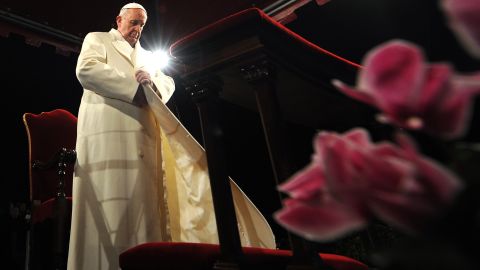 Pope Francis puts his coat on during the celebration of the Way of the Cross on Good Friday, March 29 at the Colosseum in Rome.