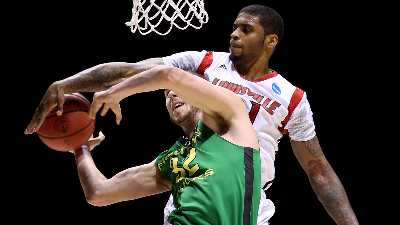 Chane Behanan of the Louisville Cardinals blocks a shot attempt by Ben Carter of the Oregon Ducks on March 29 in Indianapolis.