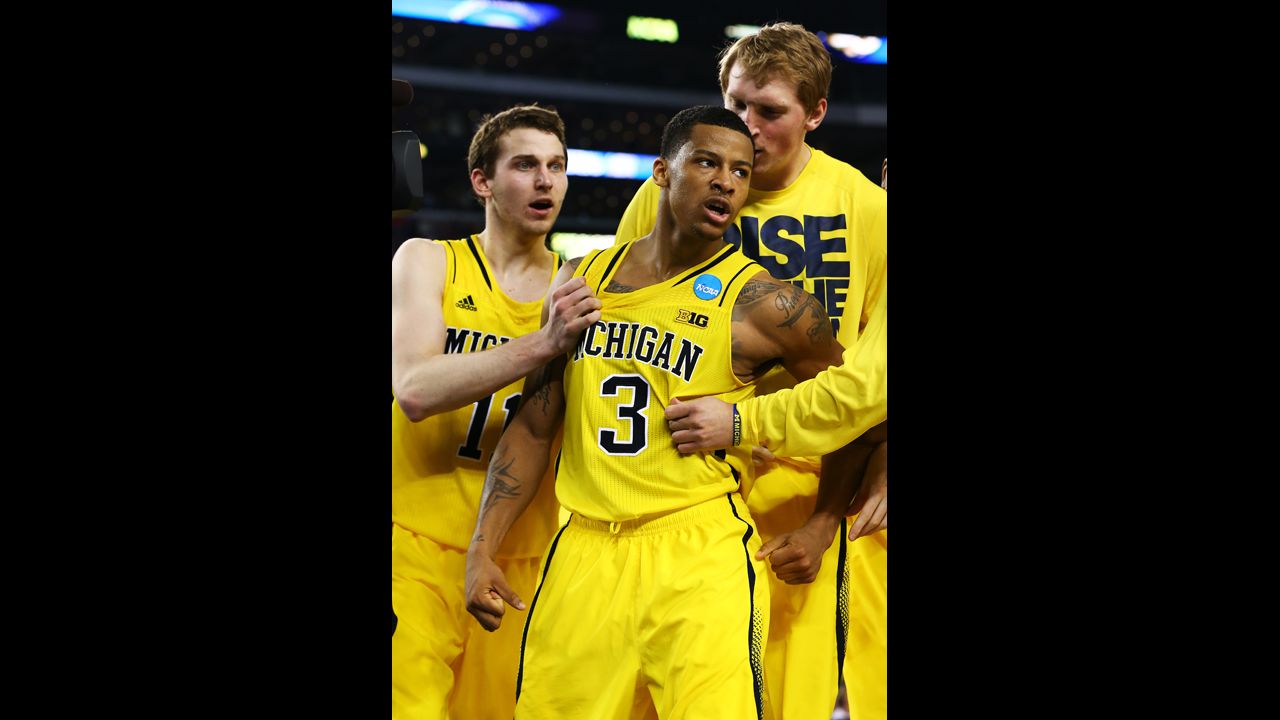 Trey Burke of Michigan, center, and teammates celebrate after Bruke shot the game-tying three pointer in the final seconds of the second half on March 29.