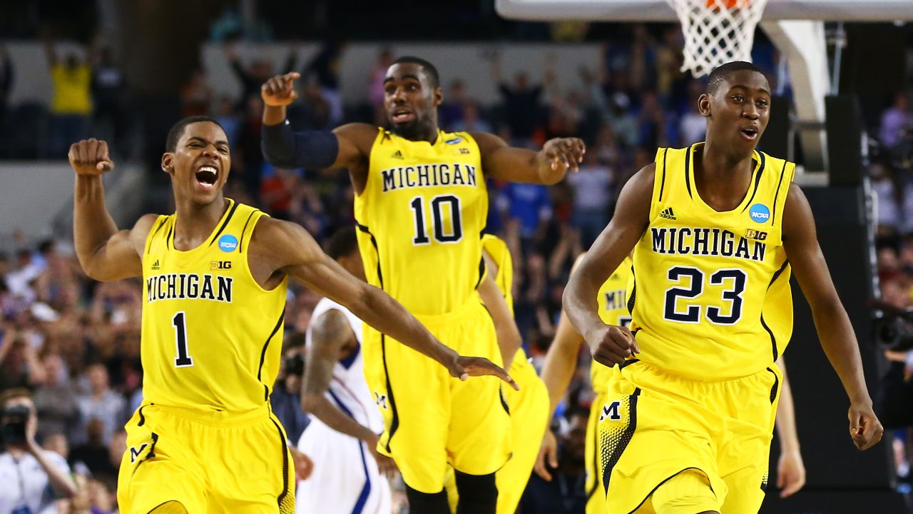 From left, Glenn Robinson III, Tim Hardaway Jr. and Caris LeVert of Michigan celebrate their 87-85 overtime win over Kansas on March 29.