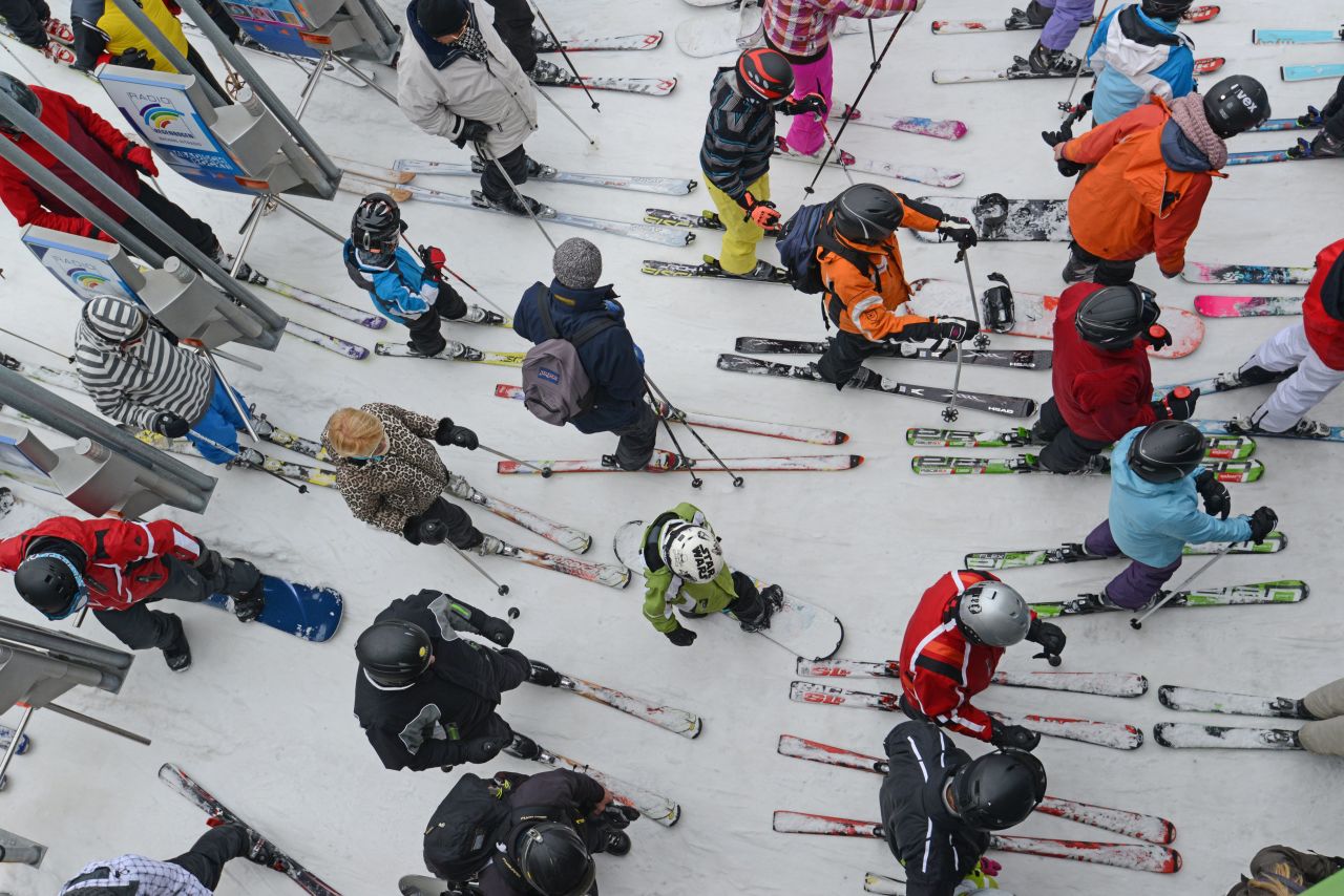 Snowboarders and skiers wait to take a ski lift at Feldberg Mountain in Schwarzwald, Germany, on Friday, March 29.