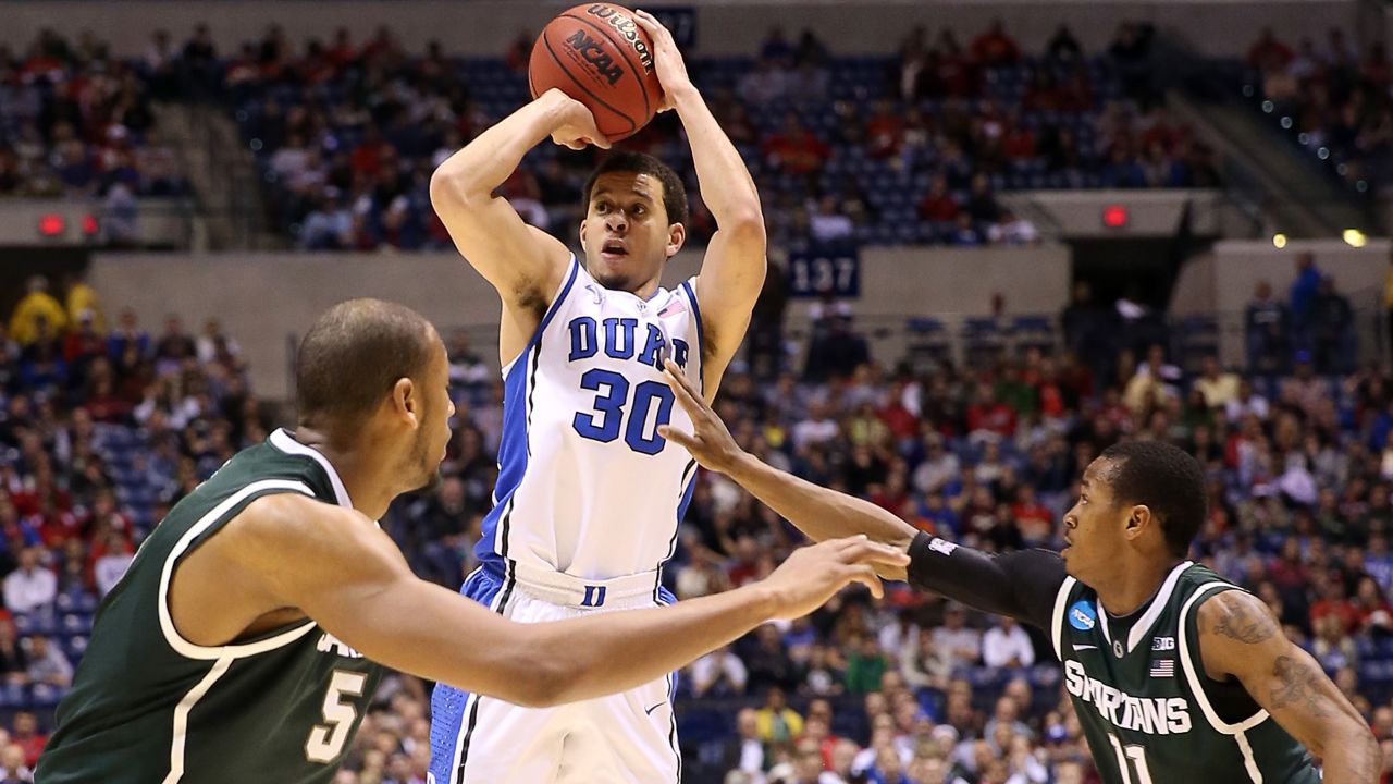 Seth Curry of the Duke Blue Devils attempts a shot over Adreian Payne, left, and Keith Appling, right, of the Michigan State Spartans on March 29 in Indianapolis.