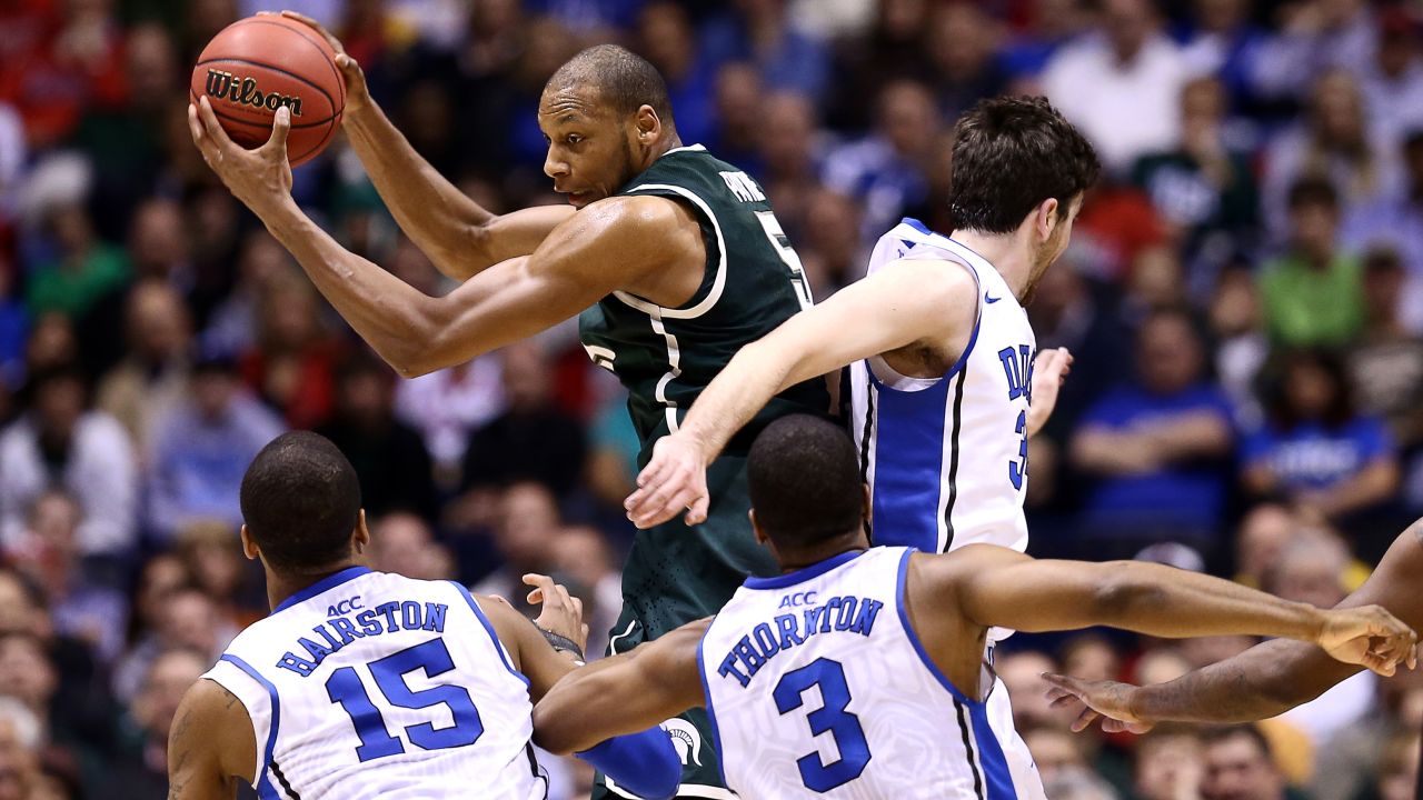 Adreian Payne of Michigan State controls a rebound against, left to right, Josh Hairston, Tyler Thornton and Ryan Kelly of Duke on March 29.