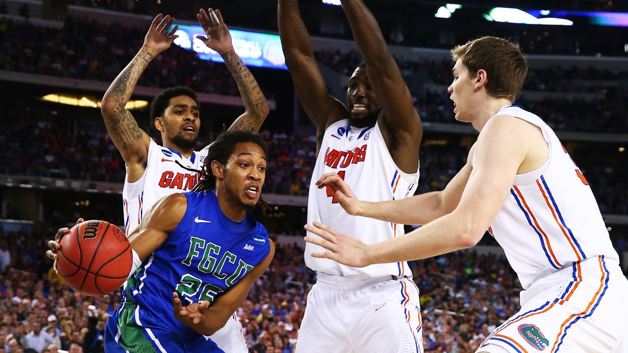 Sherwood Brown of the Florida Gulf Coast Eagles looks to pass around the Florida Gators on March 29 in Arlington, Texas. Check out the action from the fourth round of the 2013 NCAA tournament and <a href="http://www.cnn.com/2013/03/23/worldsport/gallery/ncaa-round-of-32/index.html" target="_blank">look back at the NCAA tournament Round of 32</a>.