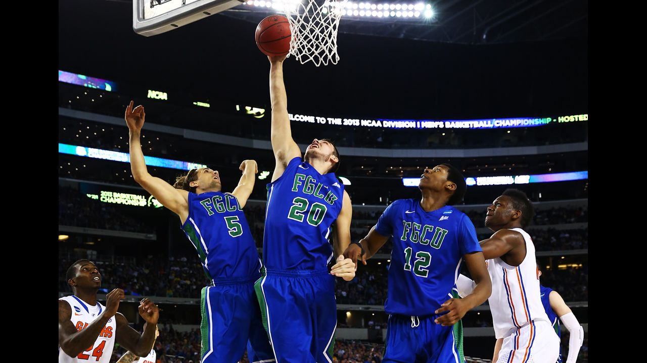 Chase Fieler rebounds between Christophe Varidel, left, and Eric McKnight, right, of Florida Gulf Coast on March 29.