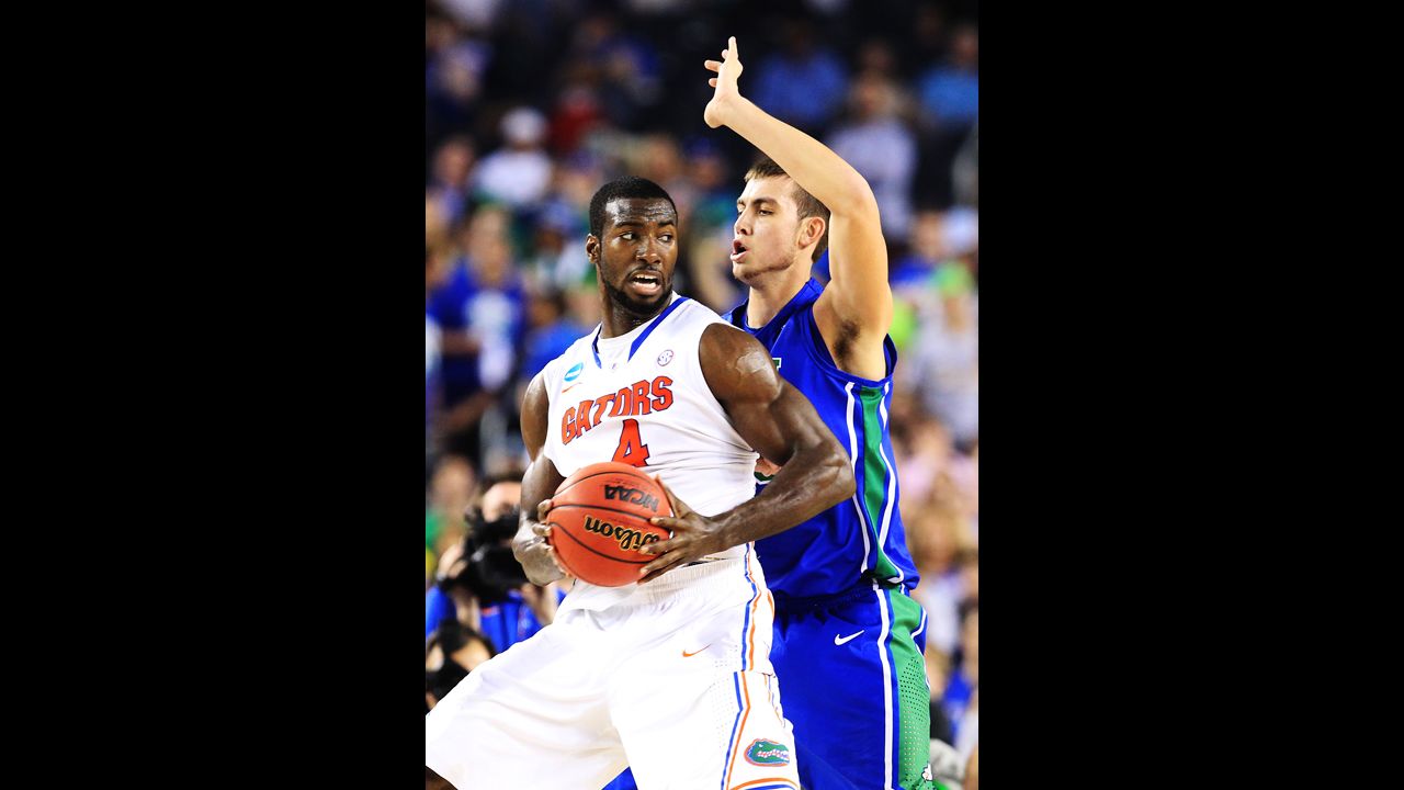 Patric Young of Florida drives against Chase Fieler of Florida Gulf Coast on March 29.