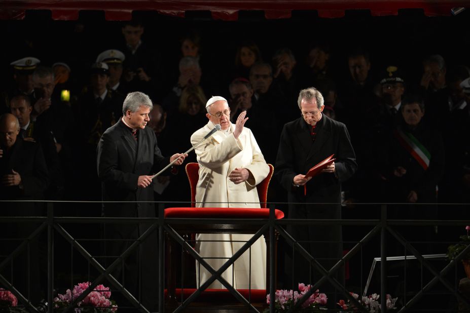 Pope Francis blesses the audience during the Way of the Cross ceremony on Good Friday.