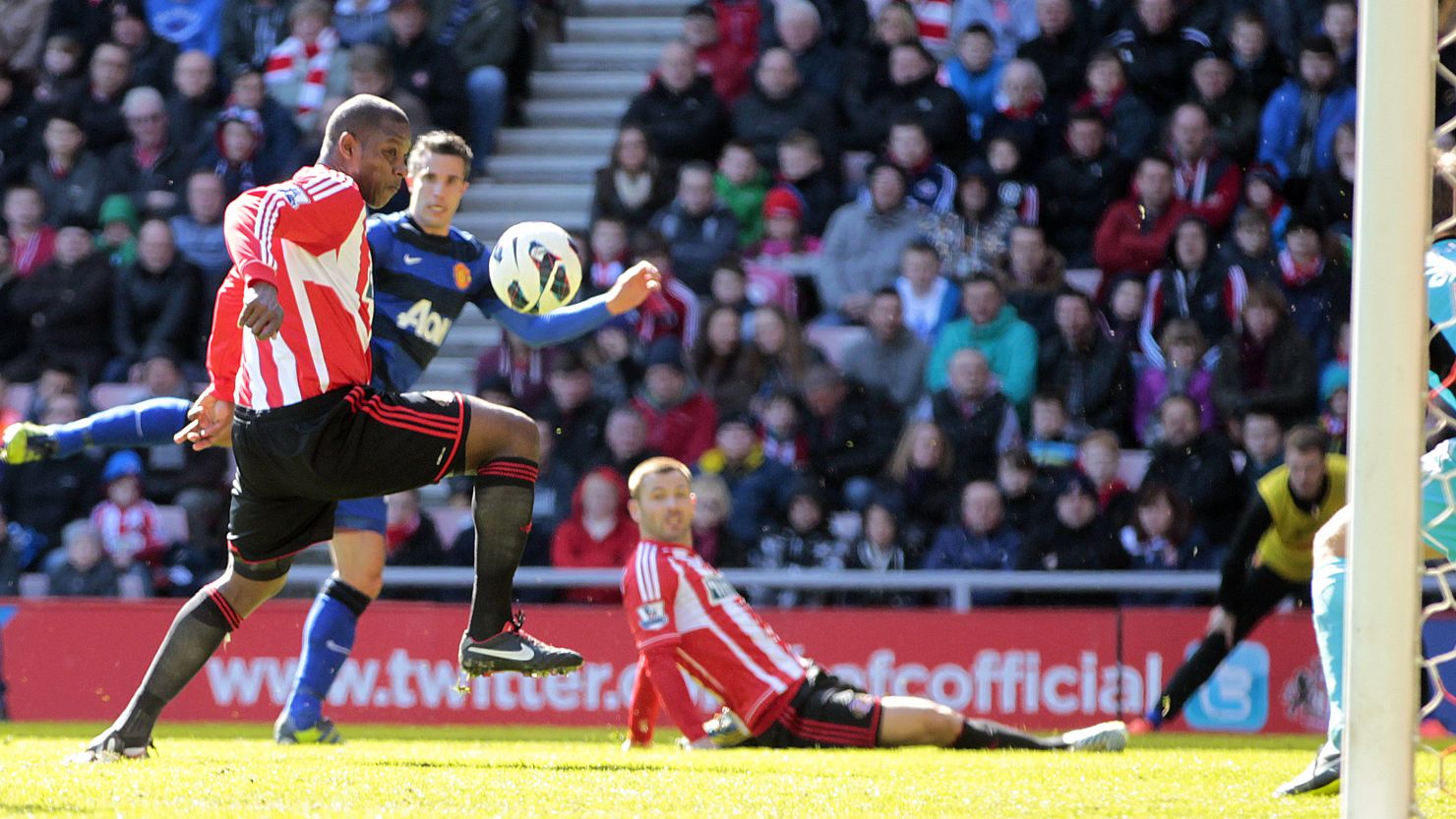Sunderland's Titus Bramble (left) deflects Robin van Persie's shot towards goal at the Stadium of Light.