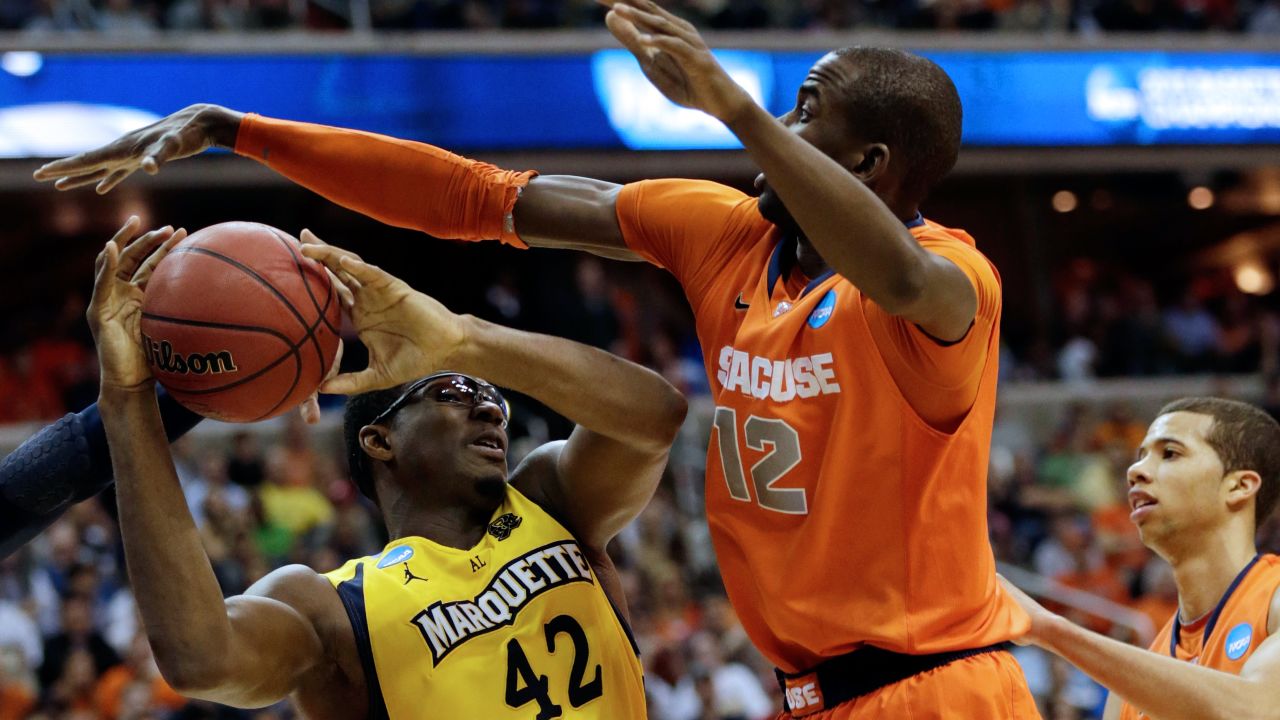 Chris Otule of Marquette draws contact against Baye Moussa Keita of Syracuse on March 30.