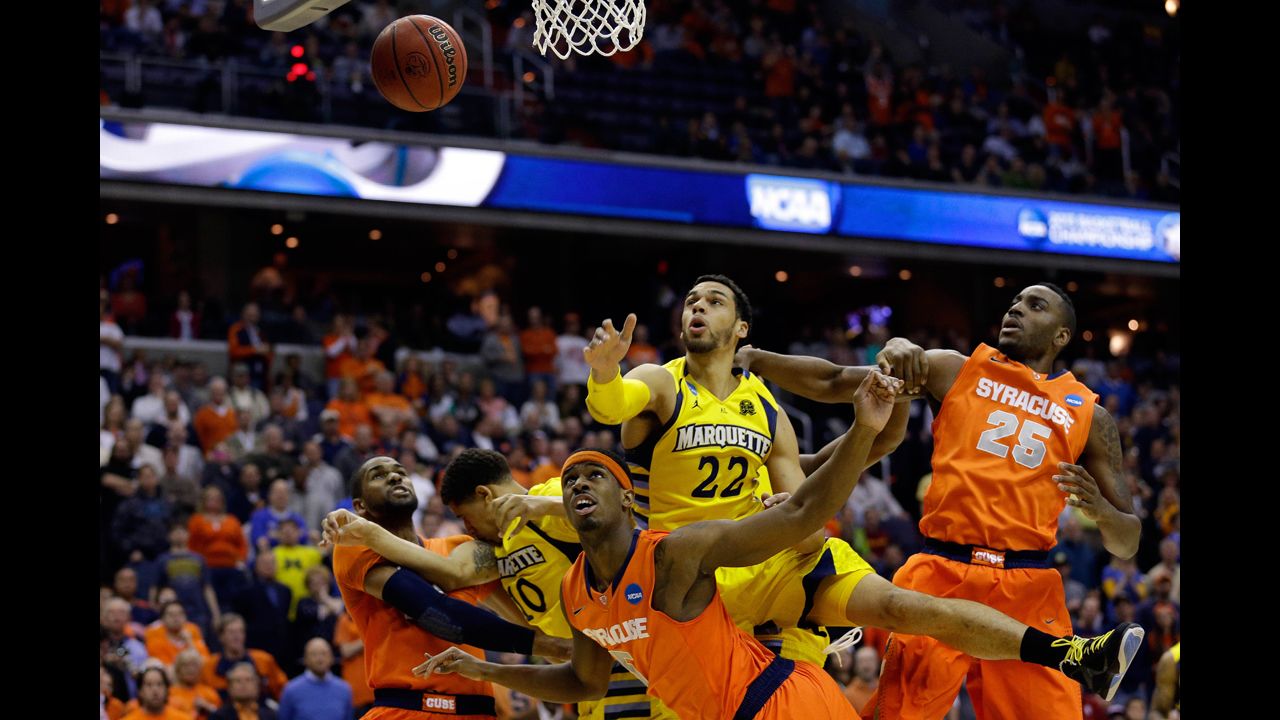 Syracuse and Marquette players fight for the rebound on March 30.