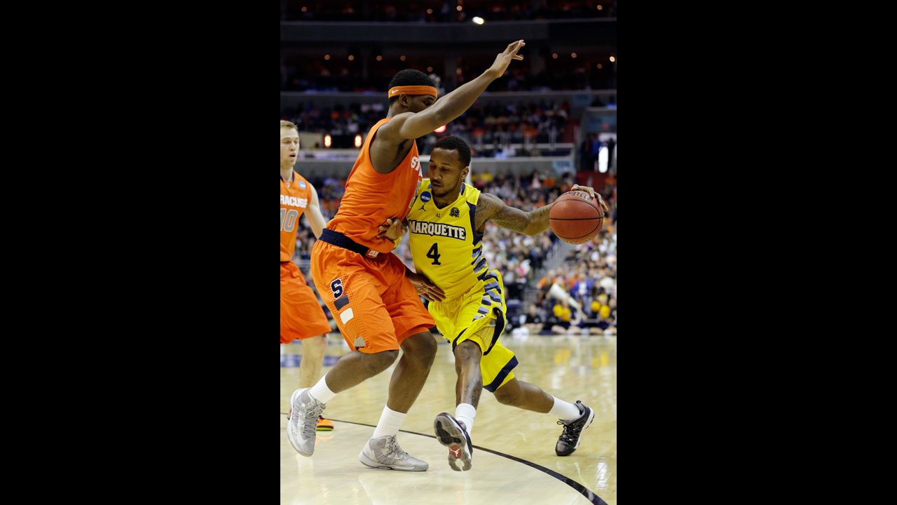 Todd Mayo of Marquette handles the ball against C.J. Fair of Syracuse on March 30.