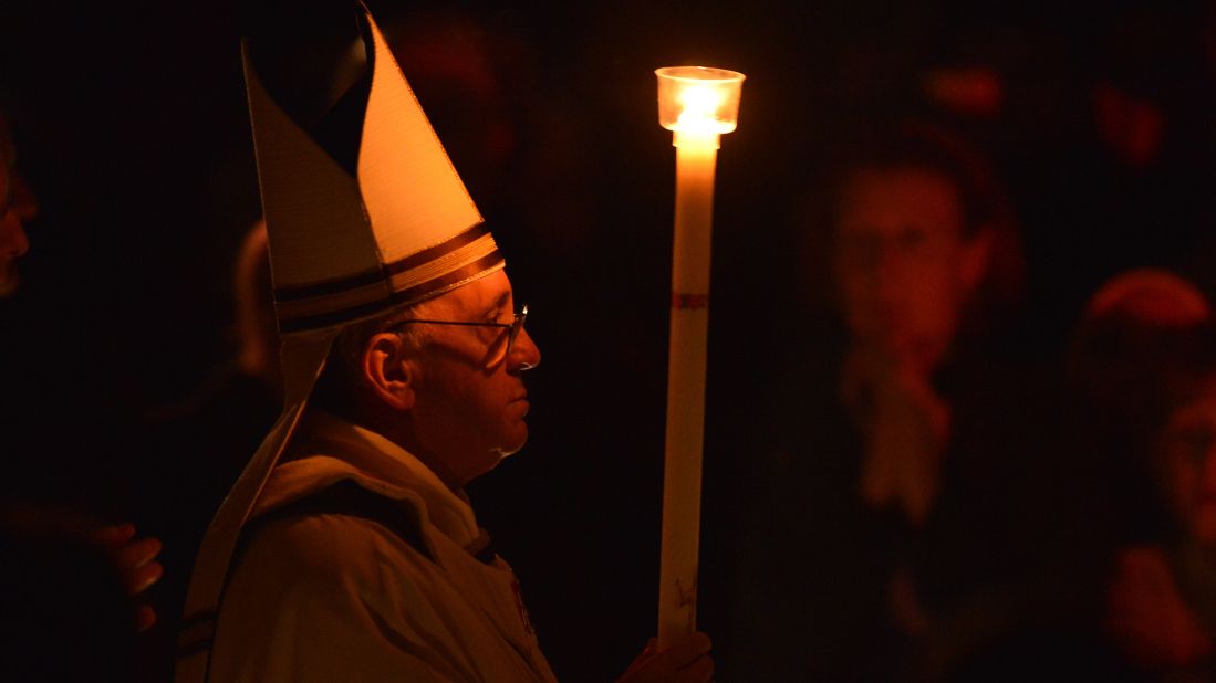 Pope Francis holds a candle during the Easter Vigil on Holy Saturday at St. Peter's Basilica on Saturday, March 30 at the Vatican. Francis is taking part in his first Holy Week as pontiff.