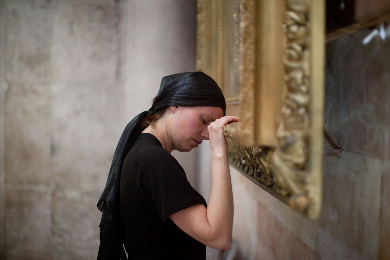 A Christian worshipper prays at the Church of the Holy Sepulchre in Jerusalem on Friday.