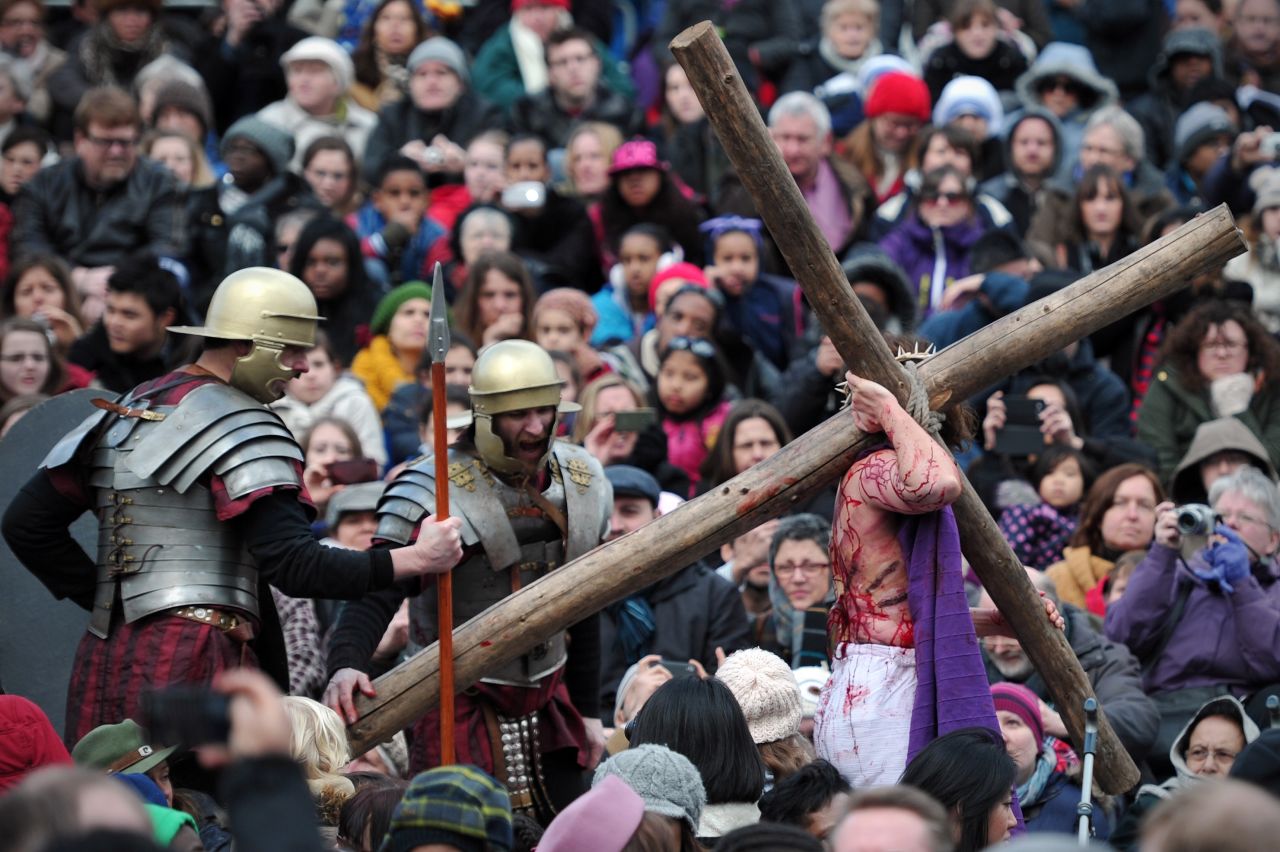 An actor playing Jesus carries a cross during the performance in Trafalgar Square in London on Friday.