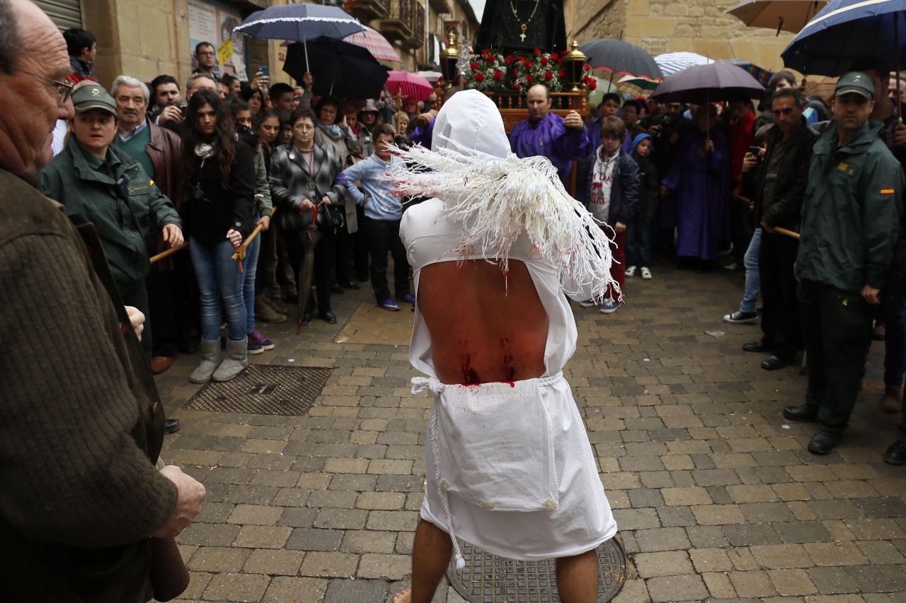 A penitent whips himself during the Santa Vera Cruz brotherhood procession for Holy Week in San Vicente de la Sonsierra, northern Spain, on Friday.