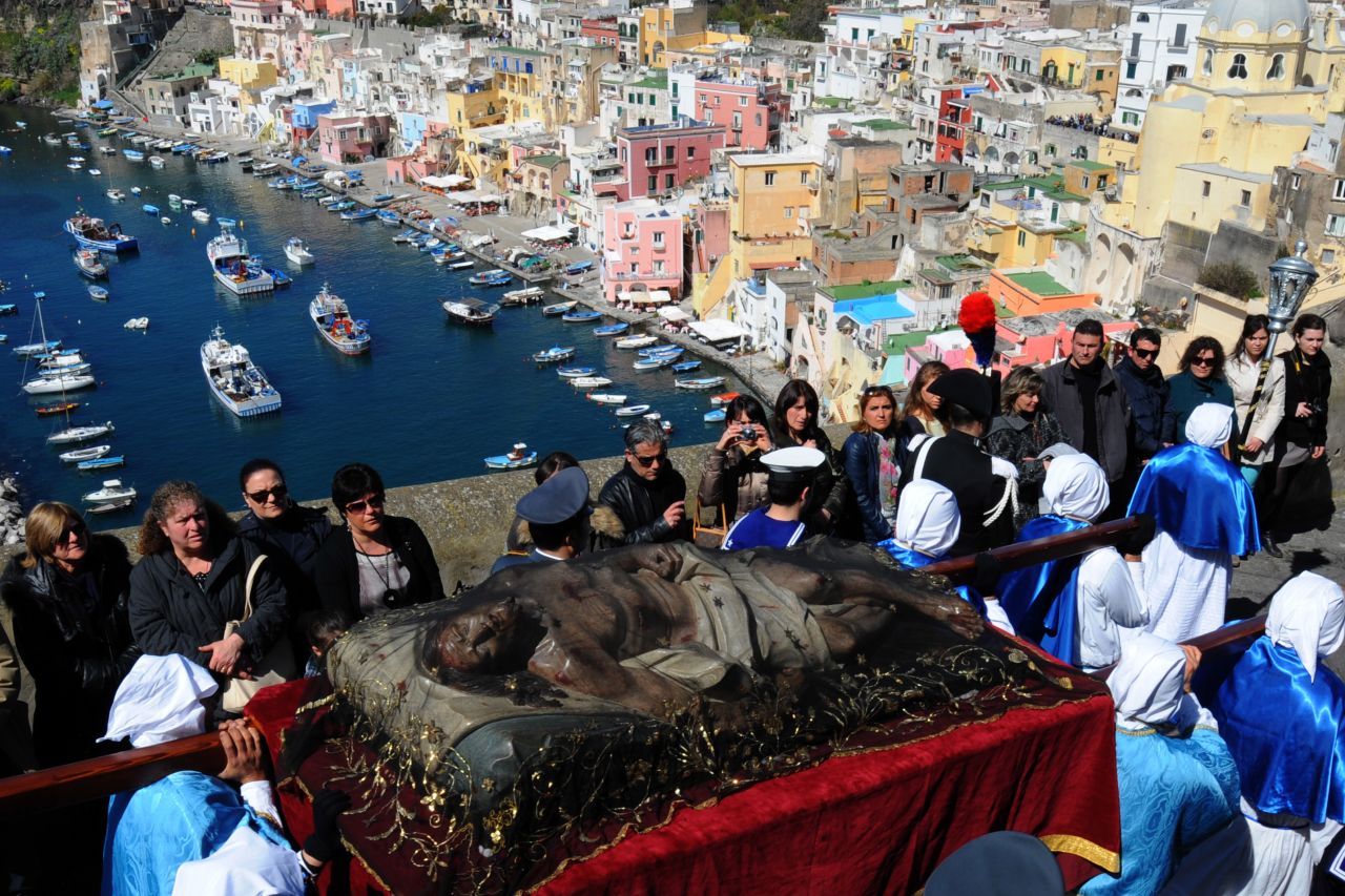 Penitents carry a Christ statue during a procession on the island of Procida off the coast of Italy on Friday.