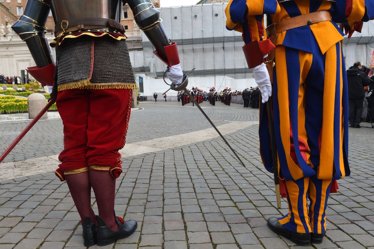 Swiss guards stand in St. Peter's Square before the Easter celebrations on Sunday.