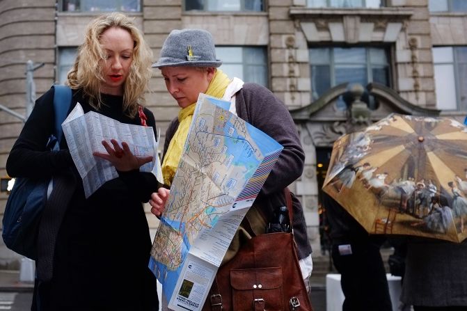That bewildered traveler holding a map upside down in our hometown. We know how she feels.