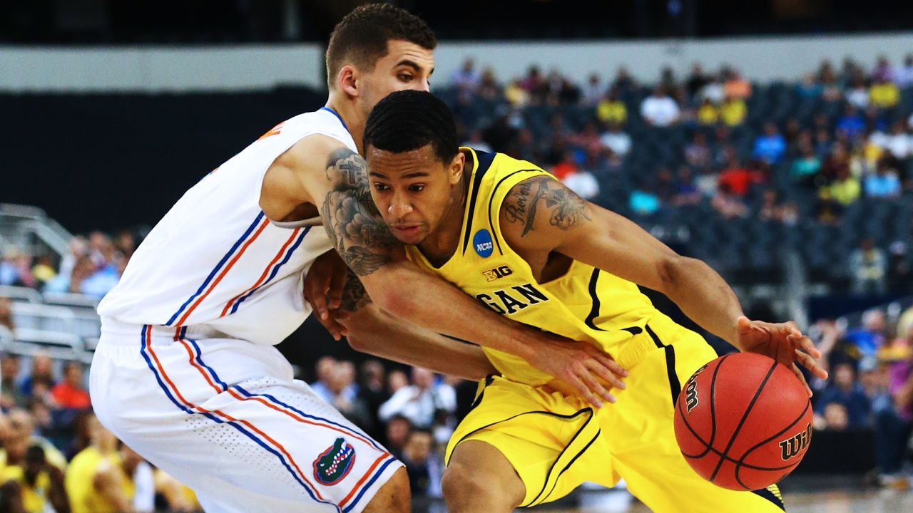Trey Burke of the Michigan Wolverines, right, drives against Scottie Wilbekin of the Florida Gators on March 31 in Arlington, Texas. Michigan beat Florida with a final score of 79-59.