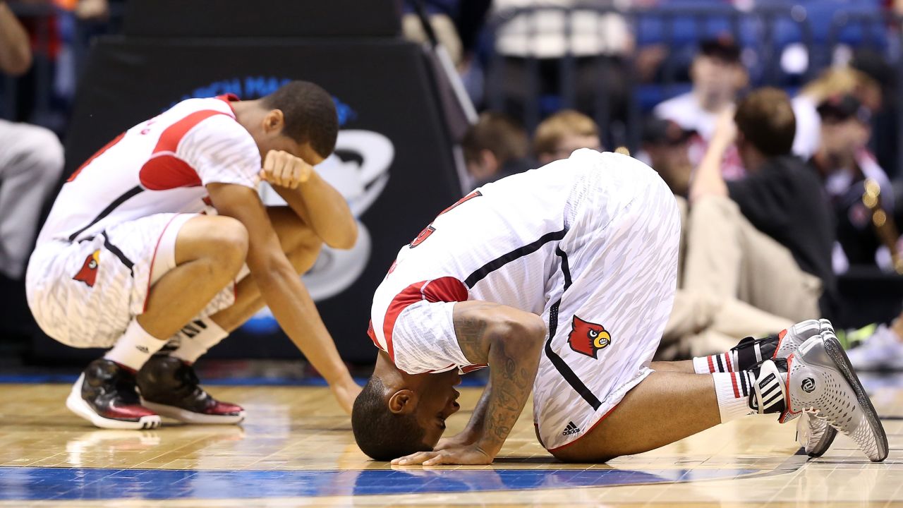Wayne Blackshear, left, and Chane Behanan of Louisville react after Kevin Ware suffered a compound fracture to his leg in the first half.