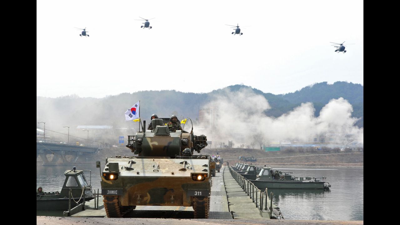 South Korean anti-aircraft armored vehicles move across a temporary bridge during a river crossing drill in Hwacheon near the North Korean border on Monday, April 1.