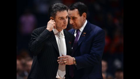 Duke head coach Mike Krzyzewski, right, shares a moment with Louisville head coach Rick Pitino as medical technicians take care of Ware.