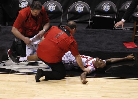 Medical staff tend to Ware after he broke his leg on Sunday, March 31.