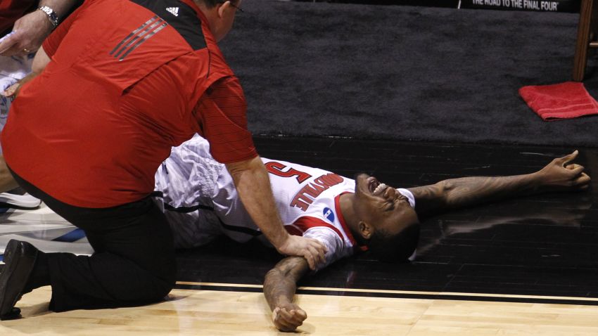 Image #: 21820076    Louisville Cardinals guard Kevin Ware (5) is attended to by medical staff after breaking his leg in the first half against the Duke Blue Devils during their Midwest Regional NCAA men's basketball game in Indianapolis, Indiana, March 31, 2013.   REUTERS/John Sommers II (UNITED STATES  - Tags: SPORT BASKETBALL TPX IMAGES OF THE DAY)         REUTERS /JOHN SOMMERS II /LANDOV