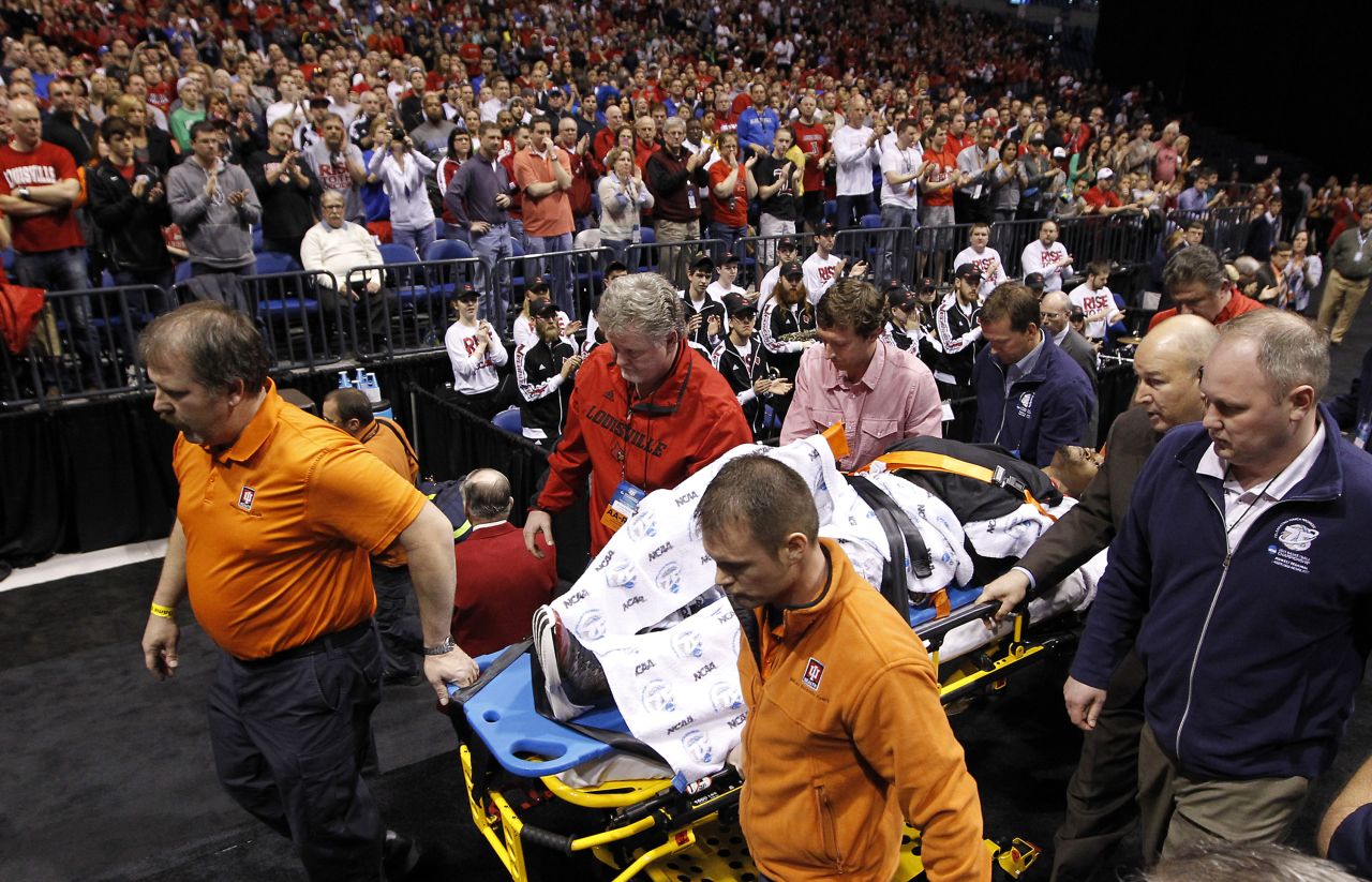 Ware is taken off the court on a stretcher.