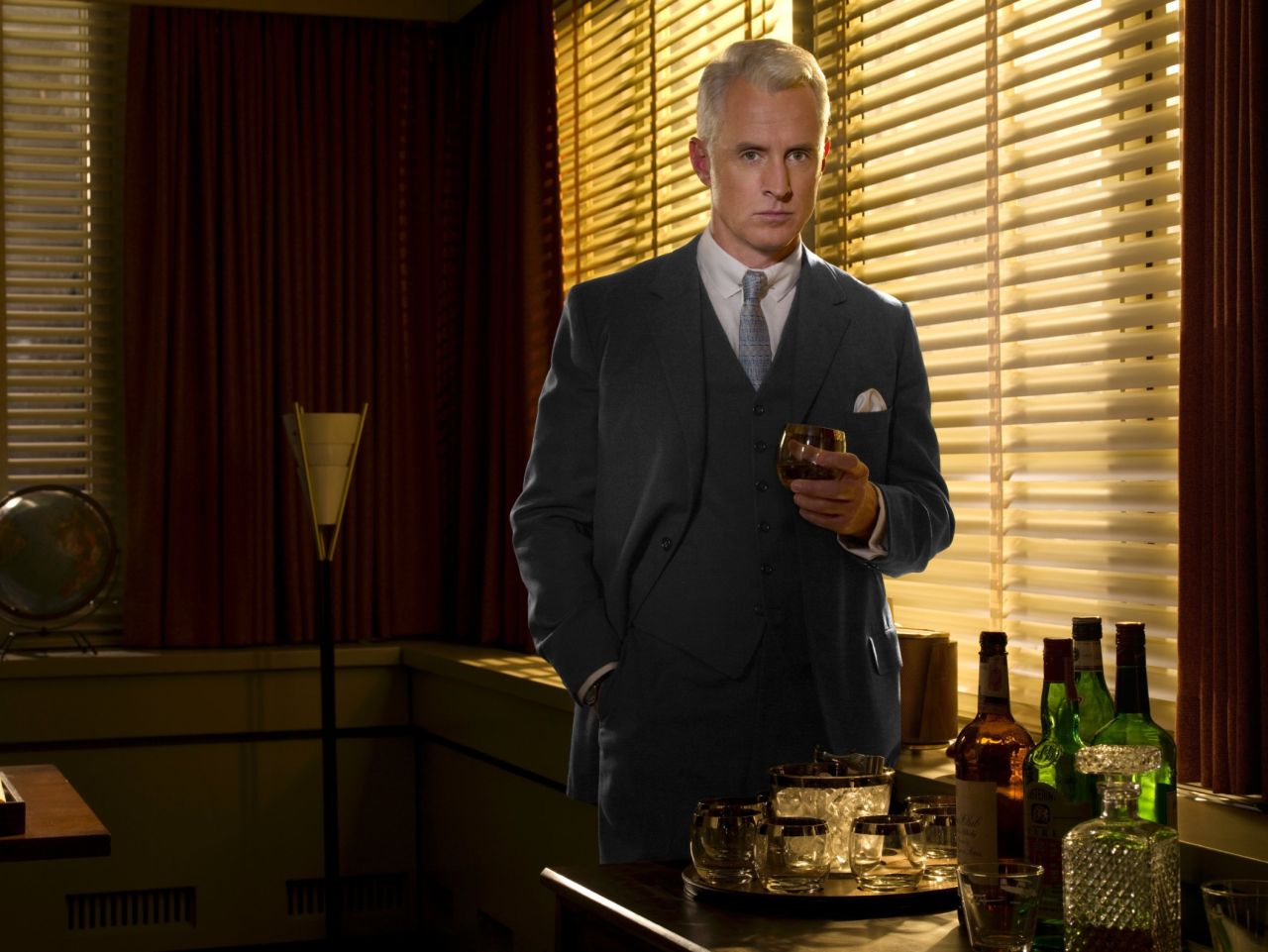 John Slattery plays Roger Sterling, here in season 2, set in the year 1962. Sterling's father co-founded the agency Sterling Cooper.