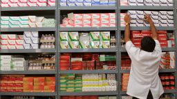 An Indian pharmacist pulls out a box of medicines from a shelf at a Generic Drug Store at the Victoria Hospital in Bangalore on June 28, 2012.
