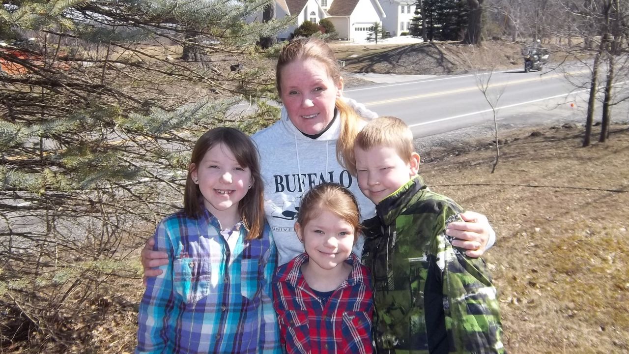 Tracy Scarpulla and her three children, Emma, Georgia and Remmington, outside of their home.