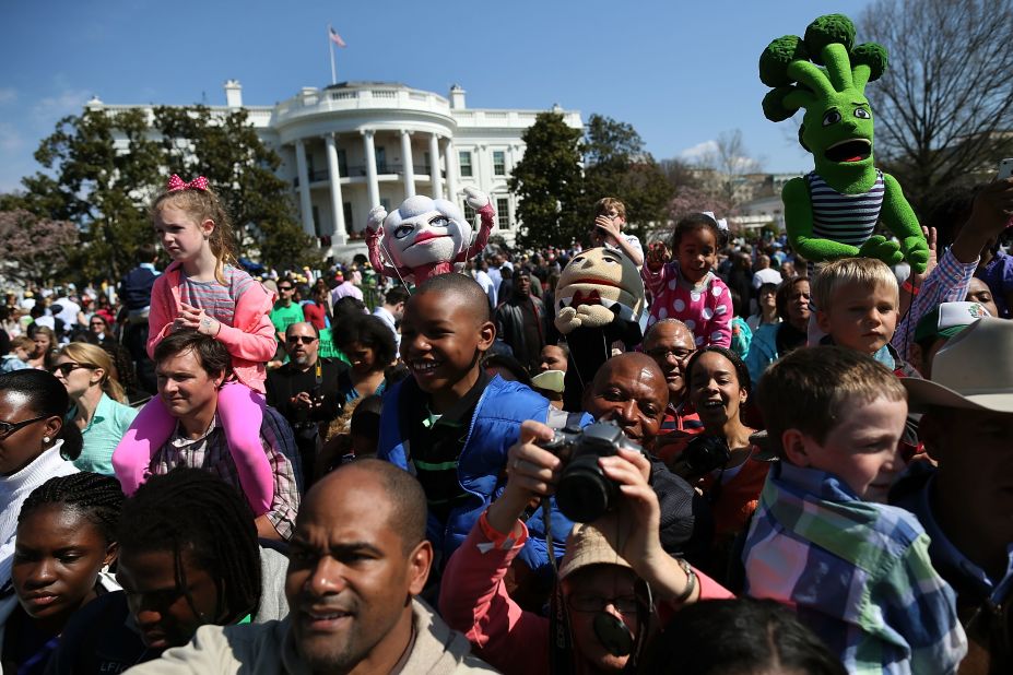 People watch as President Obama reads a book to children during the event.
